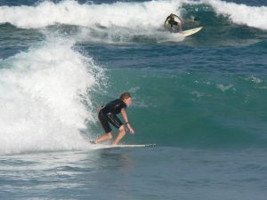 Young man balancing on surf board